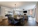 Open concept living room with fireplace, TV, dining area, and elegant chandelier lighting at 225 Dovecrest Dr, Atlanta, GA 30305
