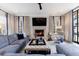 Cozy living room with a fireplace, modern lighting and blue and white patterned furniture at 225 Dovecrest Dr, Atlanta, GA 30305