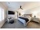 Spacious main bedroom with a comfortable seating area, TV, ceiling fan, and ensuite bathroom at 225 Dovecrest Dr, Atlanta, GA 30305