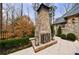 Outdoor stone fireplace with decorative lanterns and a stone patio, perfect for enjoying the outdoors at 225 Dovecrest Dr, Atlanta, GA 30305
