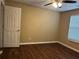 Cozy bedroom with hardwood floors, a ceiling fan and a window at 2655 Fort Apachee Trl, Dacula, GA 30019