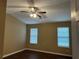 Bedroom with wood floors, ceiling fan, two windows and a closet at 2655 Fort Apachee Trl, Dacula, GA 30019