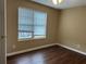 This bedroom features hardwood floors, neutral walls, and a window for natural light at 2655 Fort Apachee Trl, Dacula, GA 30019