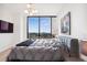 Bedroom with big window view, modern chandelier, and art piece above the bed at 2828 Peachtree Nw Rd # 1002, Atlanta, GA 30305