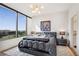 Bright bedroom features a large window, modern chandelier and eye-catching modern art at 2828 Peachtree Nw Rd # 1002, Atlanta, GA 30305