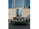Elegant building entrance featuring a water fountain and meticulously landscaped surroundings at 2828 Peachtree Nw Rd # 1002, Atlanta, GA 30305