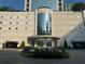 Elegant building entrance with water fountain and manicured flowerbeds at 2828 Peachtree Nw Rd # 1002, Atlanta, GA 30305