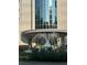 Close-up of a building entrance with a fountain and lush landscaping at 2828 Peachtree Nw Rd # 1002, Atlanta, GA 30305