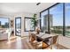 Bright dining room features modern light fixture, wood floors, and amazing city views at 2828 Peachtree Nw Rd # 1002, Atlanta, GA 30305