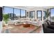 Bright living room with floor-to-ceiling windows and a large comfortable sectional sofa at 2828 Peachtree Nw Rd # 1002, Atlanta, GA 30305