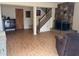 Inviting living room with stone fireplace, staircase, and wood-look floors provides a cozy atmosphere at 288 Roswell Commons Cir, Roswell, GA 30076