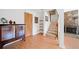 Living room featuring hardwood floors, a staircase, and a stone fireplace, blending comfort with architectural details at 288 Roswell Commons Cir, Roswell, GA 30076