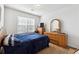 Cozy bedroom with a large window, dresser, and a comfortable bed at 403 Keys Ferry Rd, Mcdonough, GA 30252