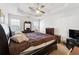 Spacious main bedroom featuring a tray ceiling, fan, and neutral decor at 403 Keys Ferry Rd, Mcdonough, GA 30252