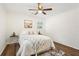 A bedroom featuring a ceiling fan, two windows, and hardwood floors at 4042 Sweetbriar Ln, Forest Park, GA 30297