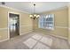 A cozy dining room with a chandelier and large window for natural light at 439 Emerald Trce, Jonesboro, GA 30236