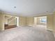 Open-concept living room with plush carpet and ample natural light at 439 Emerald Trce, Jonesboro, GA 30236