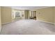 Bright living room featuring neutral walls, plush carpet, and a large bay window at 439 Emerald Trce, Jonesboro, GA 30236