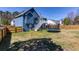 Expansive backyard featuring a trampoline, wooden fencing and the back of a blue home at 4570 Grove Park Nw Way, Acworth, GA 30101