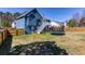 Large backyard with mature trees, trampoline, deck, and fencing, great for outdoor activities at 4570 Grove Park Nw Way, Acworth, GA 30101