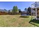 Expansive backyard featuring a trampoline, lush lawn, and a secure fence for worry-free play at 4570 Grove Park Nw Way, Acworth, GA 30101