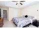 Bright bedroom with ceiling fan and tray ceiling at 4570 Grove Park Nw Way, Acworth, GA 30101