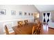 Formal dining area with a wooden table set, framed artwork, and access to a living area at 4570 Grove Park Nw Way, Acworth, GA 30101