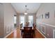 Formal dining room with hardwood floors and a neutral color palette with a view into the living room at 4570 Grove Park Nw Way, Acworth, GA 30101
