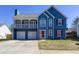 Charming two-story home with blue siding, a covered porch, and a two-car garage at 4570 Grove Park Nw Way, Acworth, GA 30101