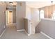 Upstairs hallway with neutral walls, carpet, and doors leading to bedrooms and bathrooms at 4570 Grove Park Nw Way, Acworth, GA 30101