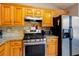 Modern kitchen featuring wood cabinets, granite counters, and stainless steel appliances at 4570 Grove Park Nw Way, Acworth, GA 30101