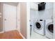 This laundry room includes a washer, dryer, and storage shelves at 4570 Grove Park Nw Way, Acworth, GA 30101