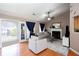 Bright living room featuring a ceiling fan, fireplace, and access to a deck or patio at 4570 Grove Park Nw Way, Acworth, GA 30101