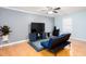 Inviting living room with a large TV, hardwood floors, and a comfortable futon at 4570 Grove Park Nw Way, Acworth, GA 30101
