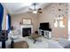 Cozy living room with a vaulted ceiling, fireplace, entertainment center, and ceiling fan at 4570 Grove Park Nw Way, Acworth, GA 30101
