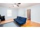Comfortable living room with hardwood floors, and a comfortable blue futon at 4570 Grove Park Nw Way, Acworth, GA 30101