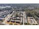 Aerial view of residential complex in a suburban area with mature trees and commercial buildings at 5629 Kingsport Dr # 11, Atlanta, GA 30342