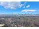 Scenic view of the Atlanta skyline with clear blue skies and trees in the foreground, creating a tranquil ambiance at 5629 Kingsport Dr # 11, Atlanta, GA 30342