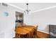 Warm dining room with hardwood floors, wooden table and view of kitchen through the doorway at 5629 Kingsport Dr # 11, Atlanta, GA 30342