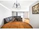 Cozy dining area with hardwood floors, stylish lighting and gray sofa near windows with light coming through at 5629 Kingsport Dr # 11, Atlanta, GA 30342