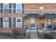 Traditional brick townhouse featuring black shutters and a covered doorway at 5629 Kingsport Dr # 11, Atlanta, GA 30342