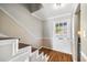 Bright foyer featuring a staircase with white risers, hardwood floors, and a welcoming ambiance at 5629 Kingsport Dr # 11, Atlanta, GA 30342
