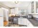 Functional kitchen featuring white cabinetry, stainless steel appliances, and a well-lit space at 5629 Kingsport Dr # 11, Atlanta, GA 30342