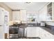 Bright kitchen featuring white cabinets, stainless steel appliances, and efficient design at 5629 Kingsport Dr # 11, Atlanta, GA 30342