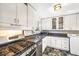 Well-lit kitchen with white cabinets, stainless steel appliances, and functional layout at 5629 Kingsport Dr # 11, Atlanta, GA 30342