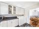 Efficient kitchen with white cabinets, countertop space, and washer dryer, flowing into the dining area at 5629 Kingsport Dr # 11, Atlanta, GA 30342