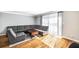 Bright living room featuring hardwood floors, large grey sofa, and natural light at 5629 Kingsport Dr # 11, Atlanta, GA 30342