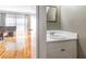 Comfortable powder room next to living room with hardwood floors and white sink at 5629 Kingsport Dr # 11, Atlanta, GA 30342
