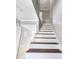 Clean white and dark wood staircase provides architectural detail and leads to upper levels at 5629 Kingsport Dr # 11, Atlanta, GA 30342
