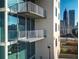 Modern building exterior with private balconies and downtown city views at 860 Peachtree Ne St # 917, Atlanta, GA 30308
